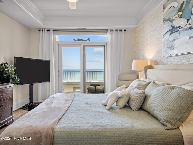 bedroom featuring baseboards, wood finished floors, access to outside, and ornamental molding