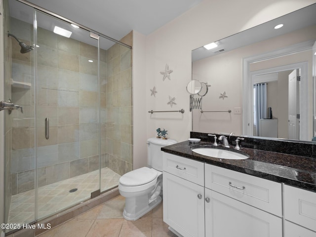 bathroom featuring an enclosed shower, vanity, toilet, and tile patterned floors