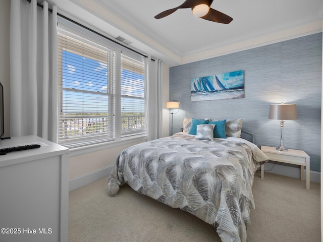 bedroom with visible vents, baseboards, ceiling fan, crown molding, and carpet floors