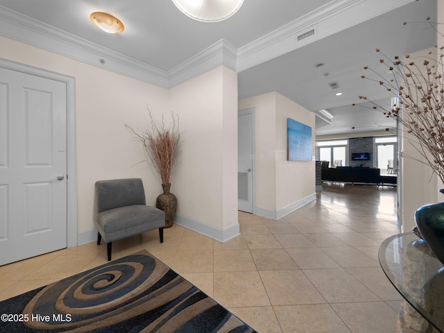 living area featuring light tile patterned floors and ornamental molding