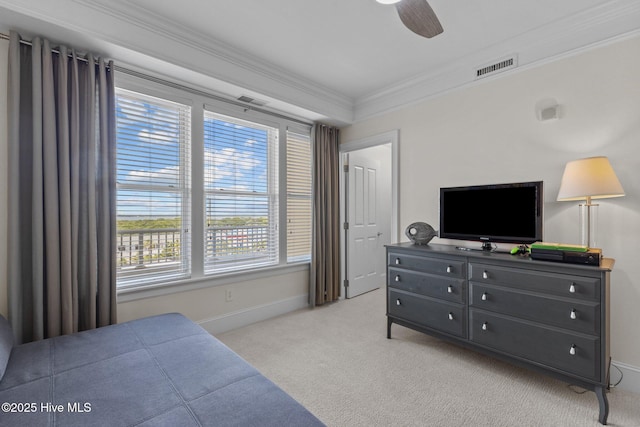 bedroom with carpet flooring, baseboards, visible vents, a ceiling fan, and crown molding