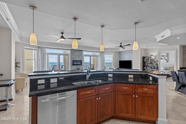 kitchen featuring hanging light fixtures, dark stone countertops, sink, and stainless steel dishwasher