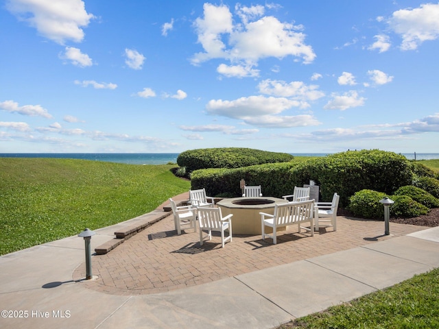 view of patio with a water view and an outdoor fire pit