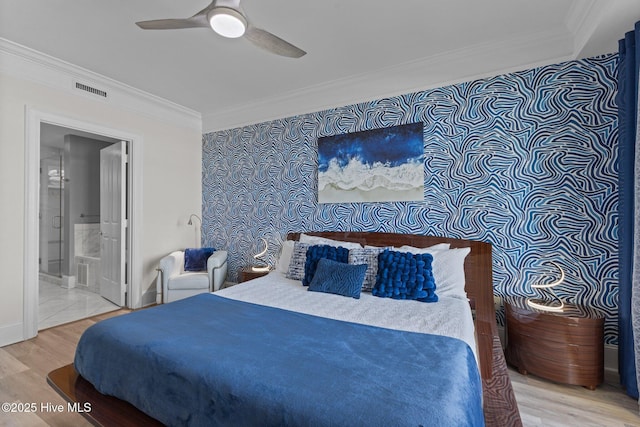 bedroom featuring hardwood / wood-style floors, ceiling fan, ornamental molding, and connected bathroom