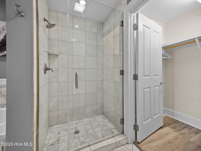 bathroom featuring wood-type flooring and walk in shower