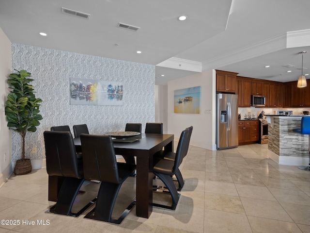 dining room featuring baseboards, visible vents, and light tile patterned floors