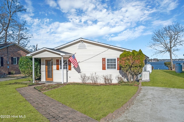 bungalow-style home with a water view, covered porch, and a front yard