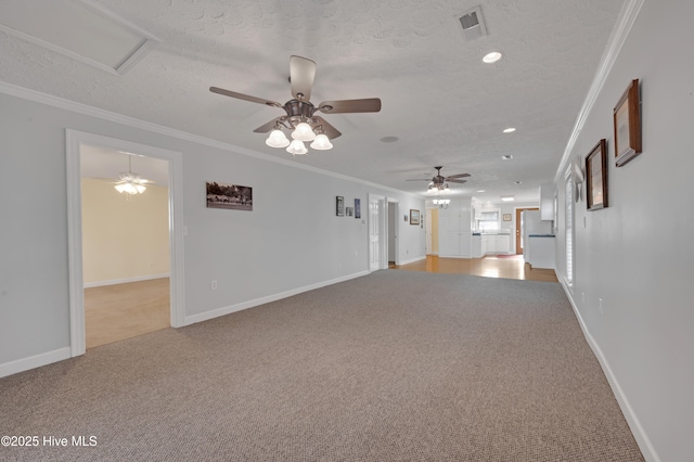 carpeted empty room with ceiling fan, a textured ceiling, and ornamental molding