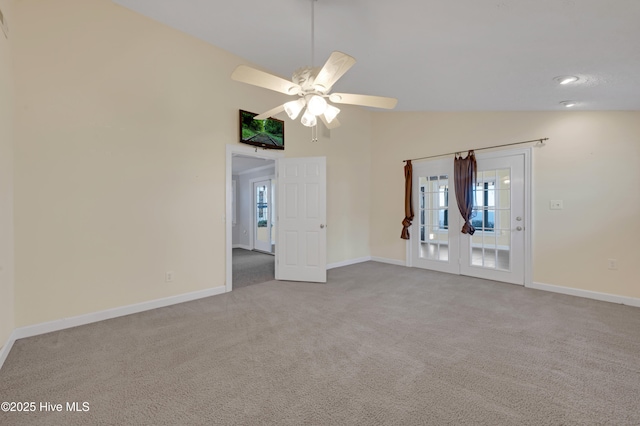 unfurnished room with ceiling fan, french doors, light colored carpet, and lofted ceiling