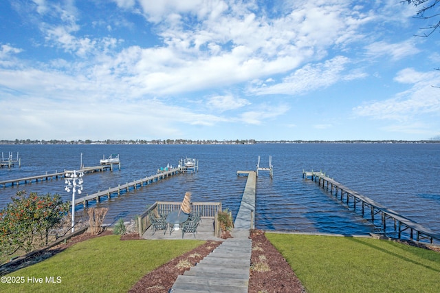 dock area featuring a yard and a water view