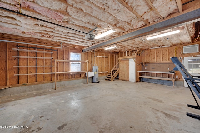 basement featuring electric water heater and a wall unit AC