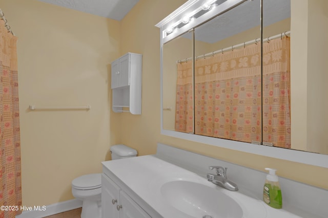 bathroom featuring vanity, a shower with shower curtain, and toilet