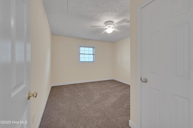 empty room with carpet, ceiling fan, and a textured ceiling