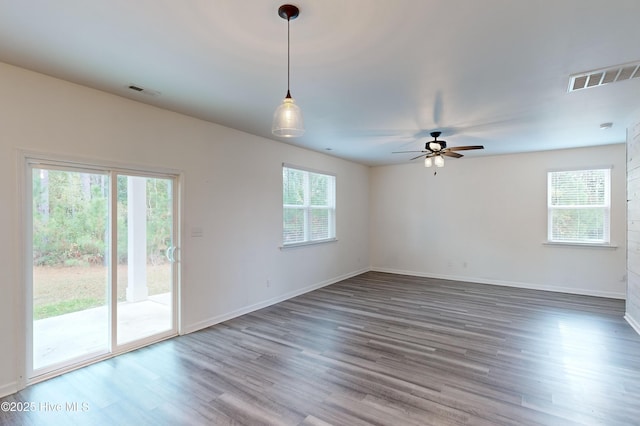 spare room featuring ceiling fan and dark wood-type flooring