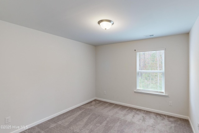 unfurnished room featuring light carpet