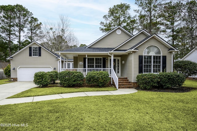 view of front facade featuring covered porch, a garage, and a front lawn