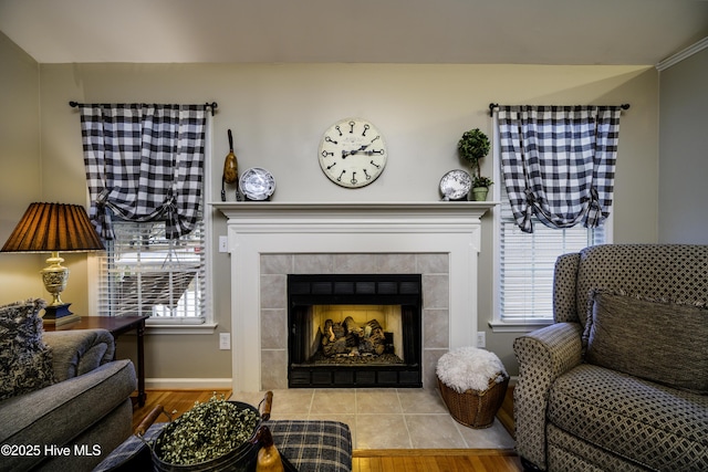 living room featuring plenty of natural light and a tiled fireplace