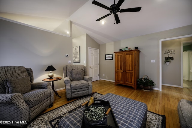 living room with light wood-type flooring, ceiling fan, and lofted ceiling