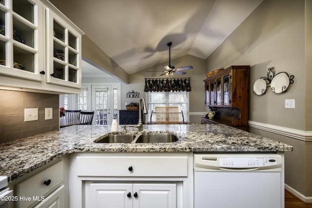 kitchen featuring tasteful backsplash, white cabinetry, sink, and white dishwasher