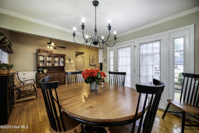 dining room featuring ceiling fan with notable chandelier, hardwood / wood-style flooring, and ornamental molding