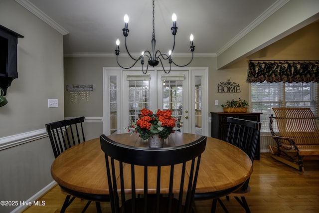 dining room featuring hardwood / wood-style floors, a notable chandelier, and ornamental molding