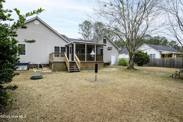 rear view of house featuring central air condition unit, a wooden deck, and a sunroom