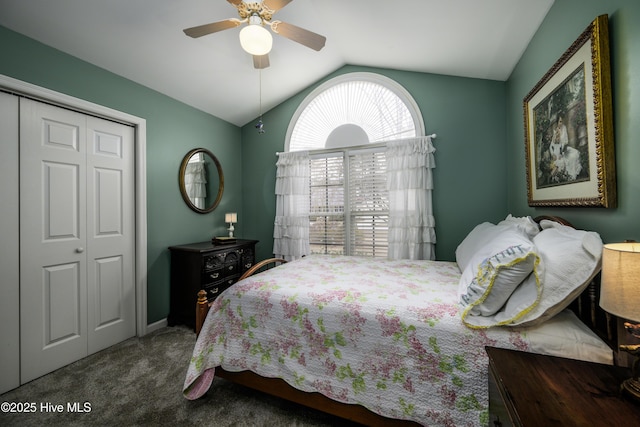 carpeted bedroom with a closet, ceiling fan, and lofted ceiling