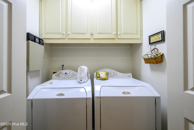 washroom with cabinets and washer and dryer