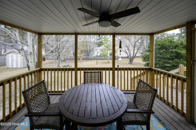 wooden terrace with ceiling fan and a shed