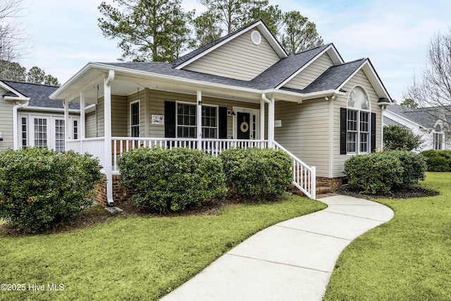 view of front facade with covered porch and a front yard