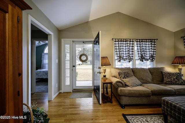 entryway with light hardwood / wood-style floors and lofted ceiling