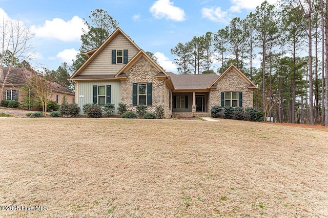 craftsman-style house featuring a front lawn and brick siding