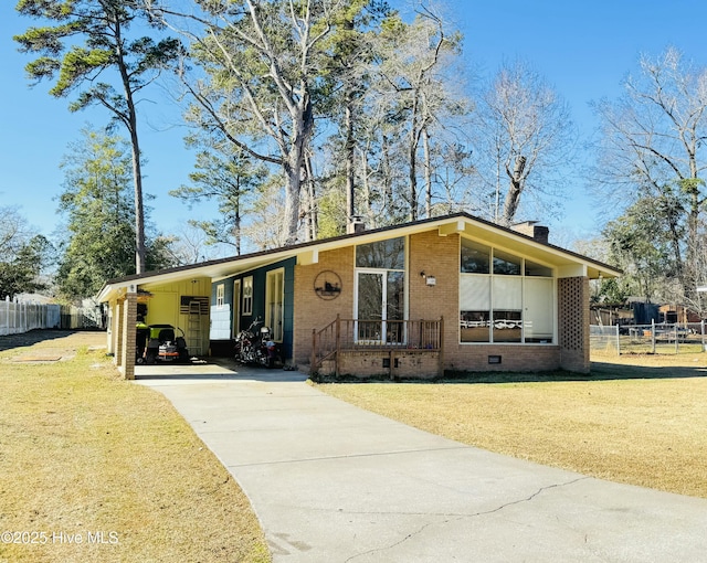 view of front of property with a front lawn and a carport