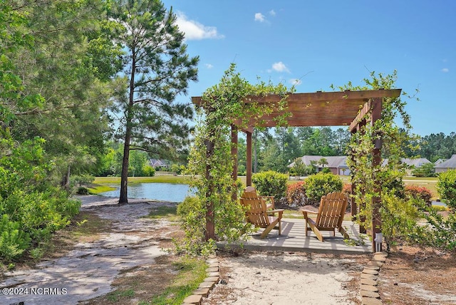 view of patio / terrace featuring a pergola and a water view