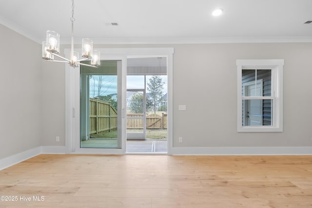 unfurnished dining area featuring light hardwood / wood-style flooring, a chandelier, and ornamental molding