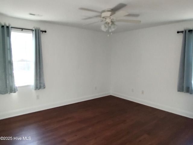 empty room featuring dark hardwood / wood-style floors and ceiling fan