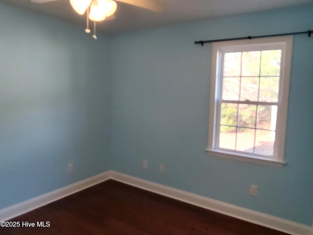 empty room with hardwood / wood-style floors and ceiling fan