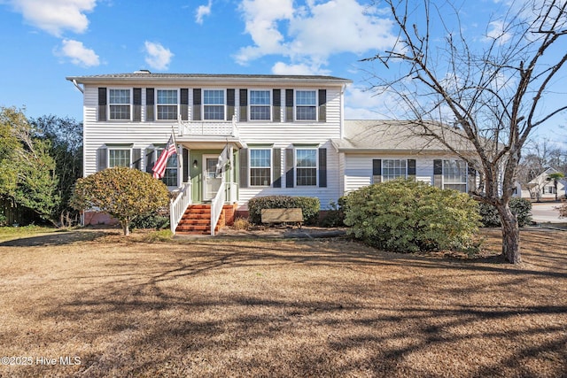 colonial inspired home with a front yard