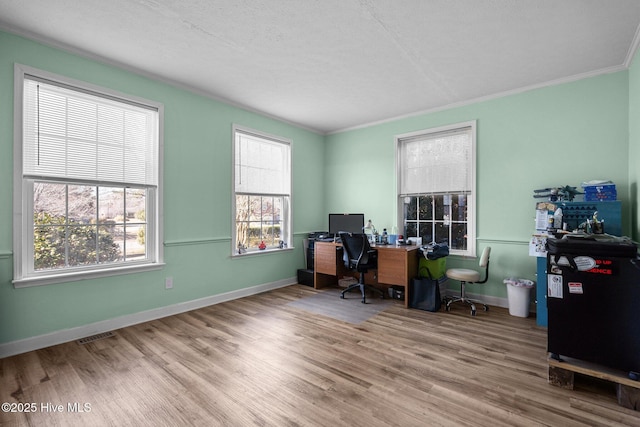 office area with ornamental molding and hardwood / wood-style floors