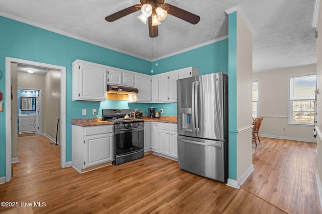 kitchen with white cabinetry, ceiling fan, stainless steel appliances, crown molding, and light hardwood / wood-style flooring