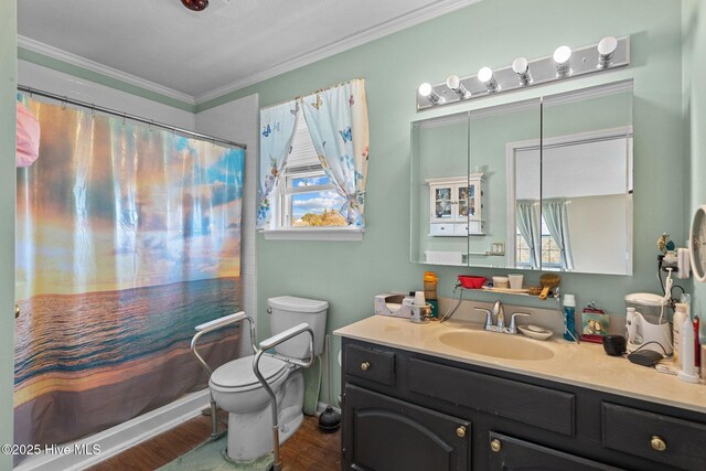 bathroom with hardwood / wood-style floors, vanity, ornamental molding, toilet, and walk in shower