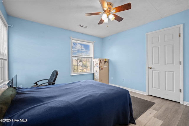 bedroom featuring ceiling fan and light hardwood / wood-style flooring