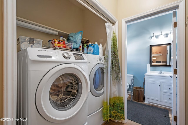 clothes washing area with separate washer and dryer and sink