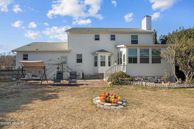 back of house featuring a patio and a lawn