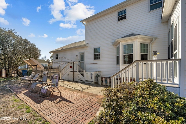 back of property featuring a gazebo and a patio area