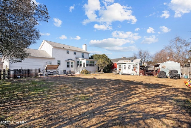 rear view of house with a storage shed