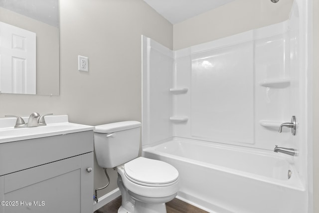 full bathroom with washtub / shower combination, vanity, wood-type flooring, and toilet