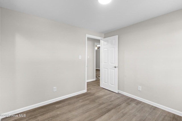 spare room with hardwood / wood-style floors