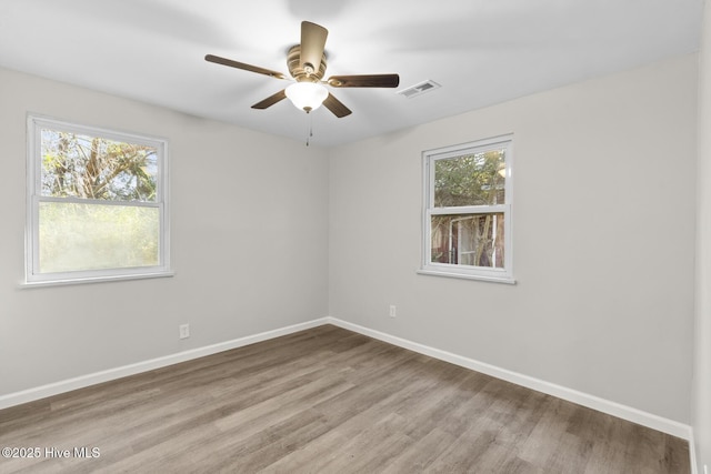 empty room featuring light hardwood / wood-style flooring and ceiling fan