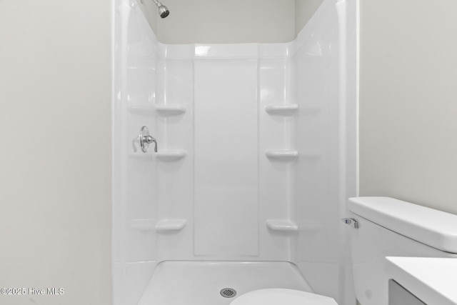 bathroom featuring toilet and walk in shower